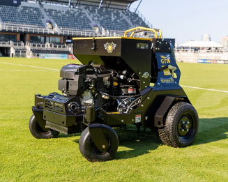 Stinger GT30 commercial stand-on aerator with integrated seed system on a green turf field